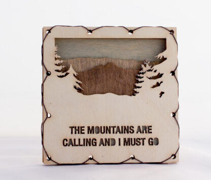 Mountains are Calling text with Mountains Home Decor with four layers of wood