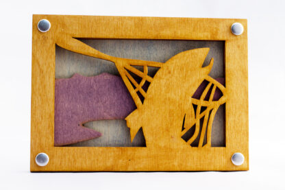 Trout caught in a net laser cut wooden wall art laser cut form natural wood, hand stained and assembled with steel grommets. Tri-layered with a brown fish, purple land, and grey background.