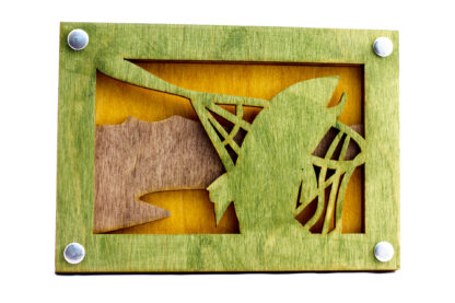 Trout caught in a net laser cut wooden wall art laser cut form natural wood, hand stained and assembled with steel grommets. Tri-layered with a green fish, brown land, and yellow background.