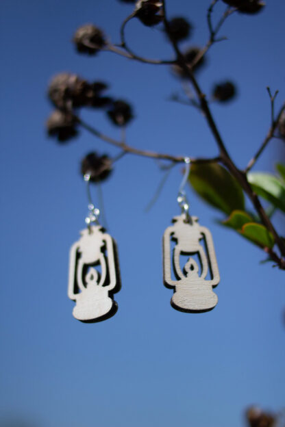 rustic lantern earrings, in white, hanging in tree