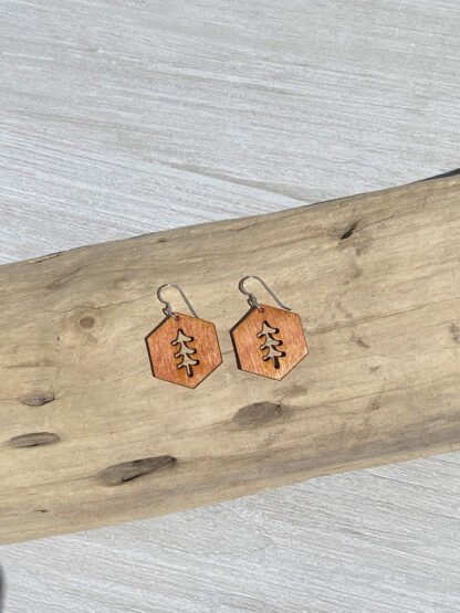 hexagon tree shape earrings, resting on wood, in orange