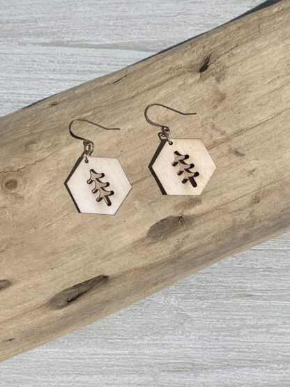 hexagon tree shape earrings, resting on wood, in natural
